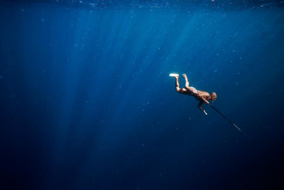 An elder of the Banjo tribe hunts for fish off the coast of Sampela, Indonesia.